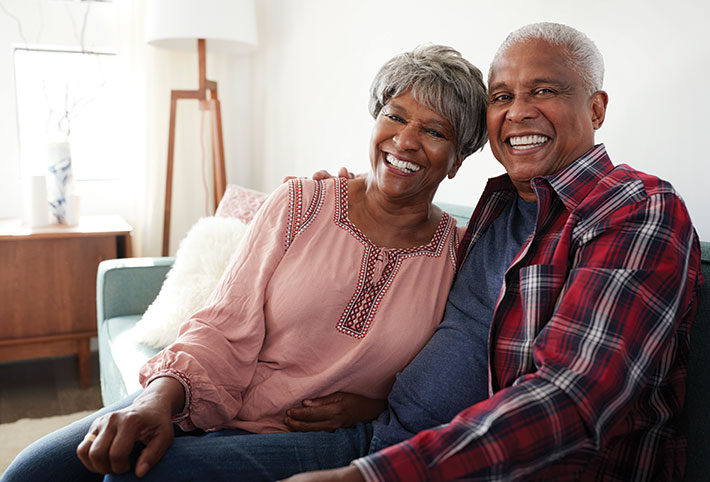 Photo of an older couple smiling. Photo of an older couple smiling.